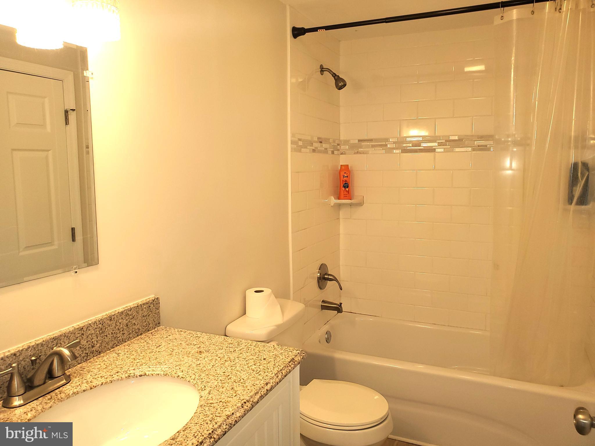 30 Colonial Circle North East, MD 21901 - Photo 13 of 15 a bathroom with a granite countertop sink toilet and shower