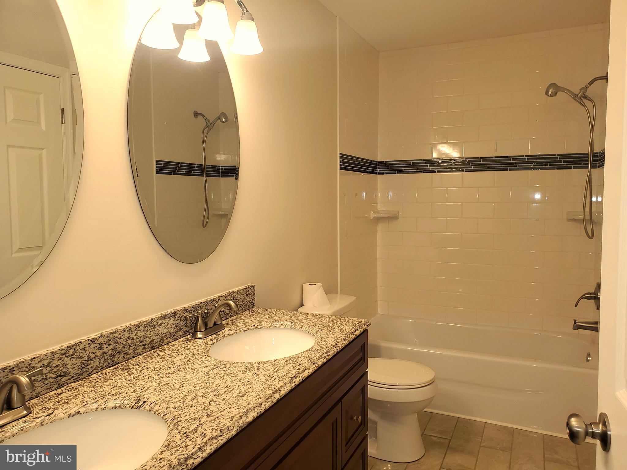 30 Colonial Circle North East, MD 21901 - Photo 7 of 15 a bathroom with a granite countertop sink mirror vanity and toilet