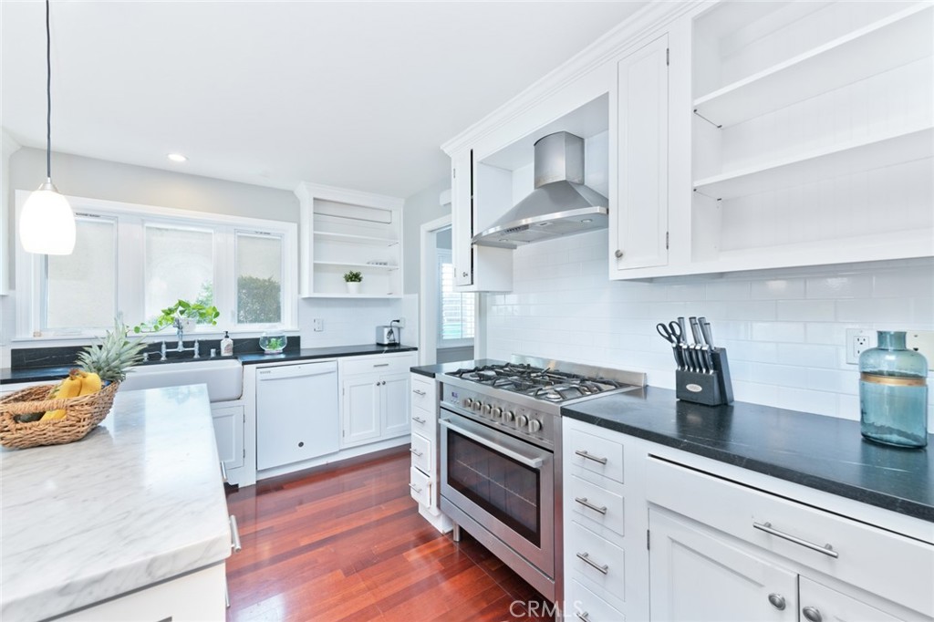 19292 Sierra Perla Road Irvine, CA 92603 - Photo 11 of 21 a kitchen with white cabinets and appliances
