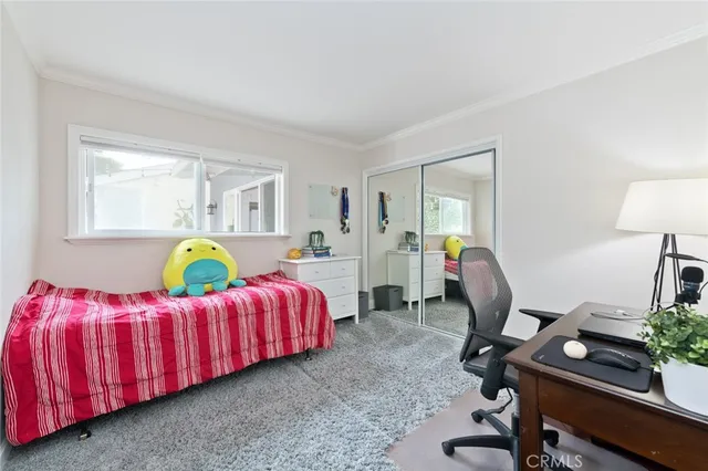 a bedroom with a bed and a desk