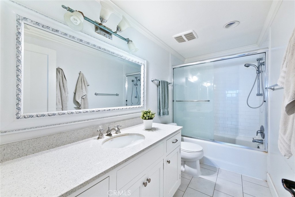 19292 Sierra Perla Road Irvine, CA 92603 - Photo 17 of 21 a bathroom with a double vanity sink toilet mirror and shower