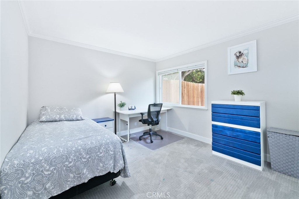 19292 Sierra Perla Road Irvine, CA 92603 - Photo 18 of 21 a bedroom with a bed and a table in it