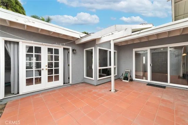 a view of a patio with a dining table and chairs with wooden fence
