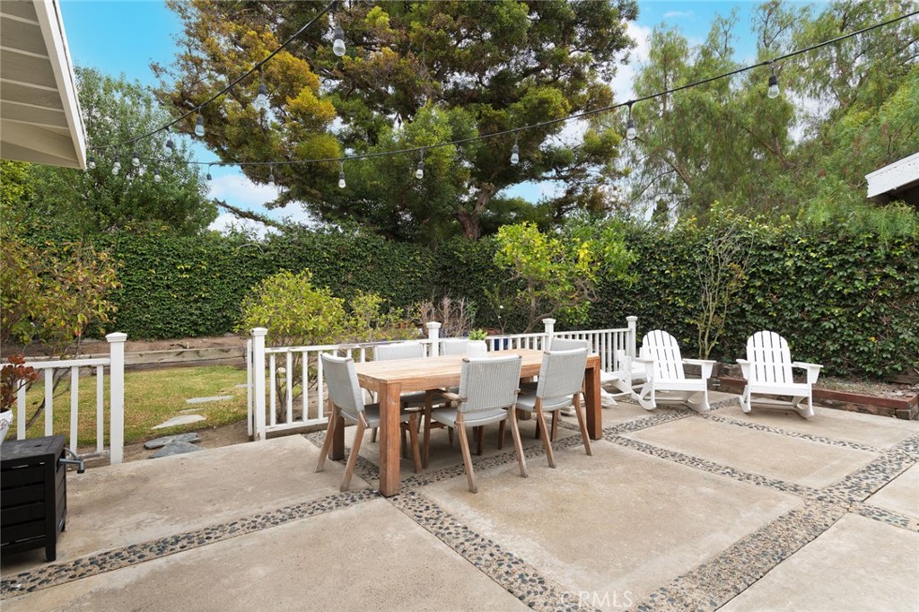 19292 Sierra Perla Road Irvine, CA 92603 - Photo 20 of 21 a view of a patio with a dining table and chairs with wooden fence