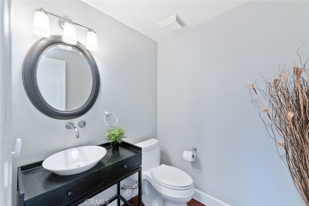 19292 Sierra Perla Road Irvine, CA 92603 - Photo 6 of 21 a bathroom with a toilet a sink and a mirror