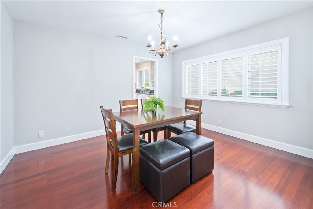 19292 Sierra Perla Road Irvine, CA 92603 - Photo 7 of 21 a living room with furniture a chandelier and a wooden floor