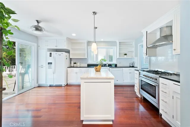 a kitchen with white cabinets and white appliances