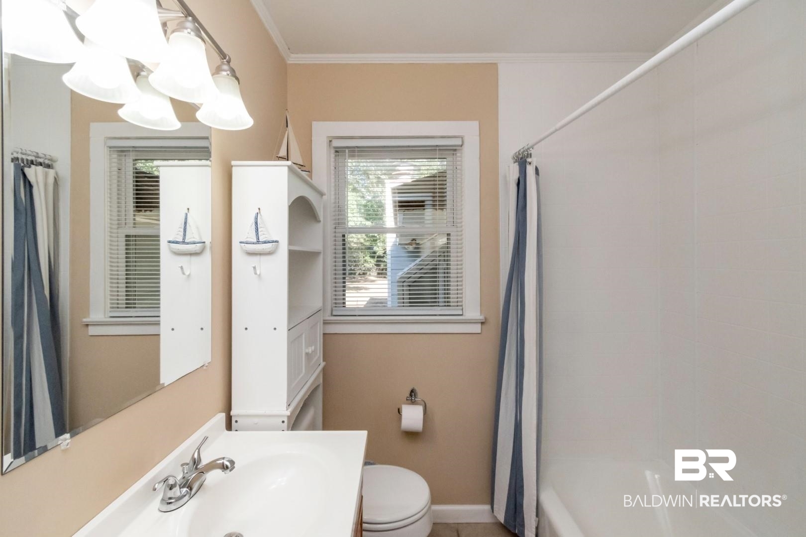 1321 Rainbow Drive West Mobile, AL 36693 - Photo 31 of 48 Full bathroom with ornamental molding, sink, toilet, and shower / bathtub combination with curtain