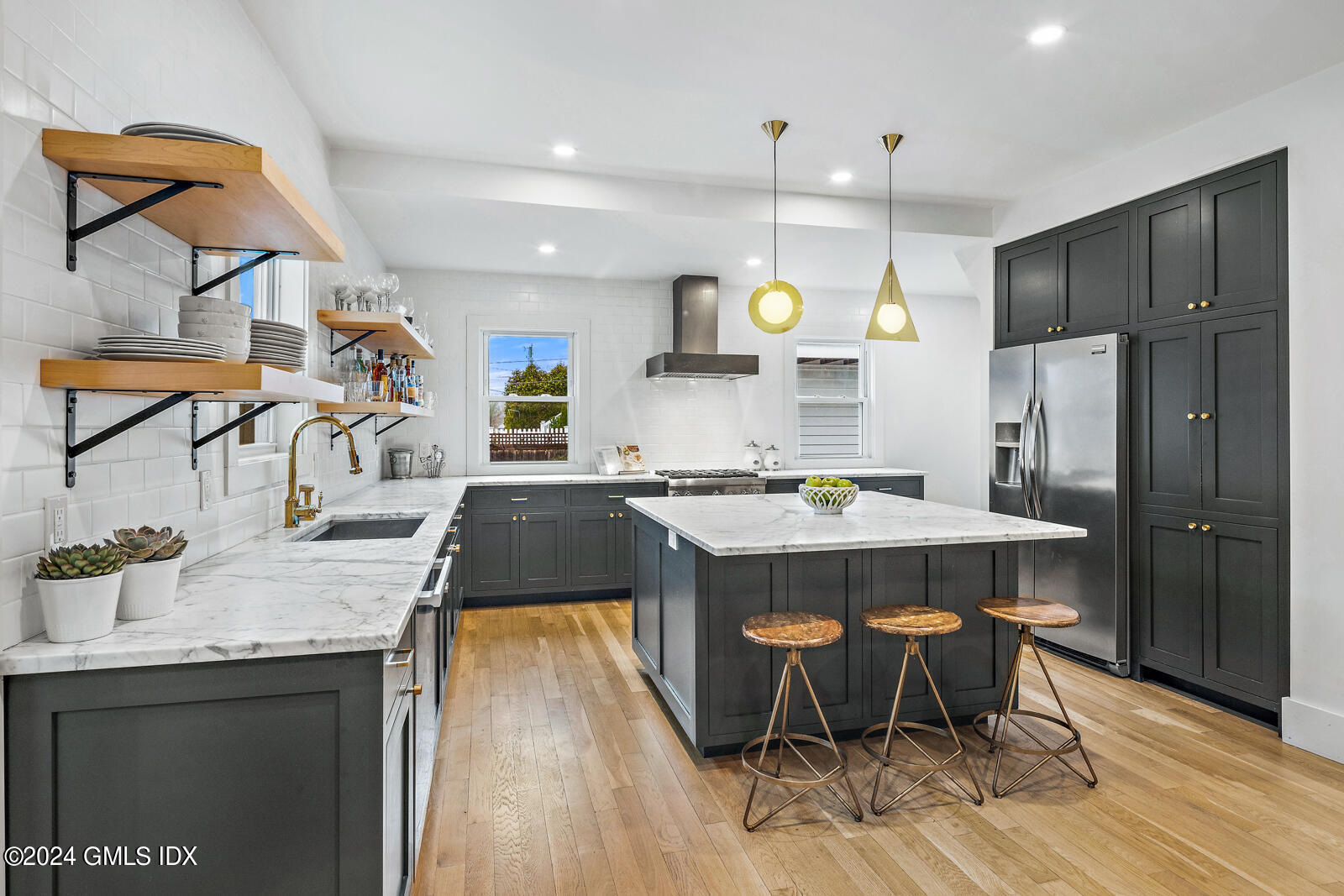 15 Elm Place Greenwich, CT 06830 - Photo 11 of 40 a kitchen with kitchen island granite countertop a sink a center island and stainless steel appliances