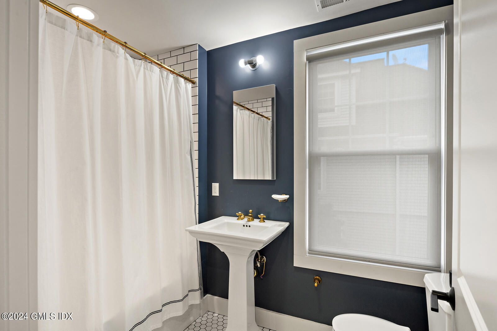 15 Elm Place Greenwich, CT 06830 - Photo 21 of 40 a bathroom with a sink vanity and a mirror