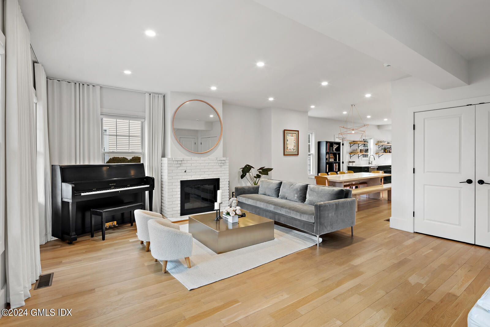 15 Elm Place Greenwich, CT 06830 - Photo 5 of 40 a living room with furniture a fireplace and a kitchen view