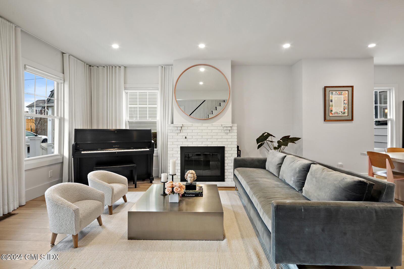 15 Elm Place Greenwich, CT 06830 - Photo 6 of 40 a living room with furniture a fireplace and a large window