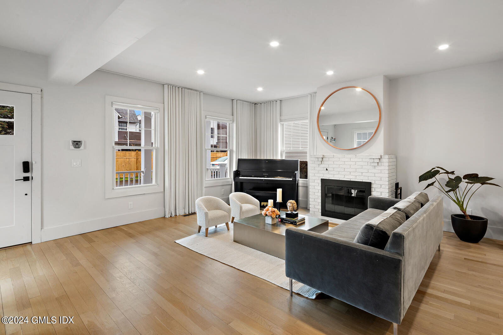 15 Elm Place Greenwich, CT 06830 - Photo 7 of 40 a living room with furniture a fireplace and a window