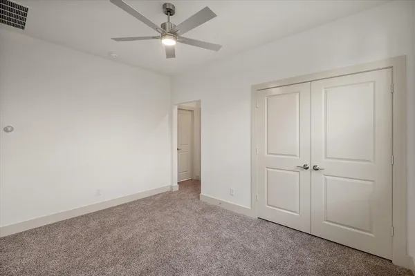 an empty room with a ceiling fan and a ceiling fan