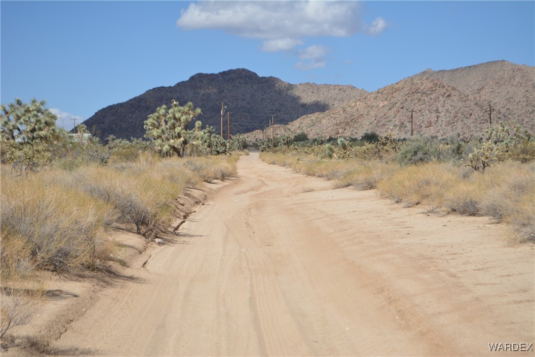 11841 Sherry Road Yucca, AZ 86438 - Photo 36 of 45 a view of a dry yard with mountains in the background