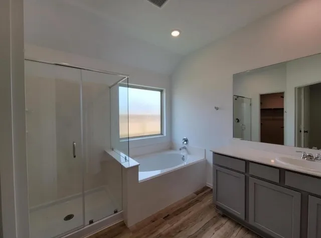 a bathroom with a bathtub and a sink