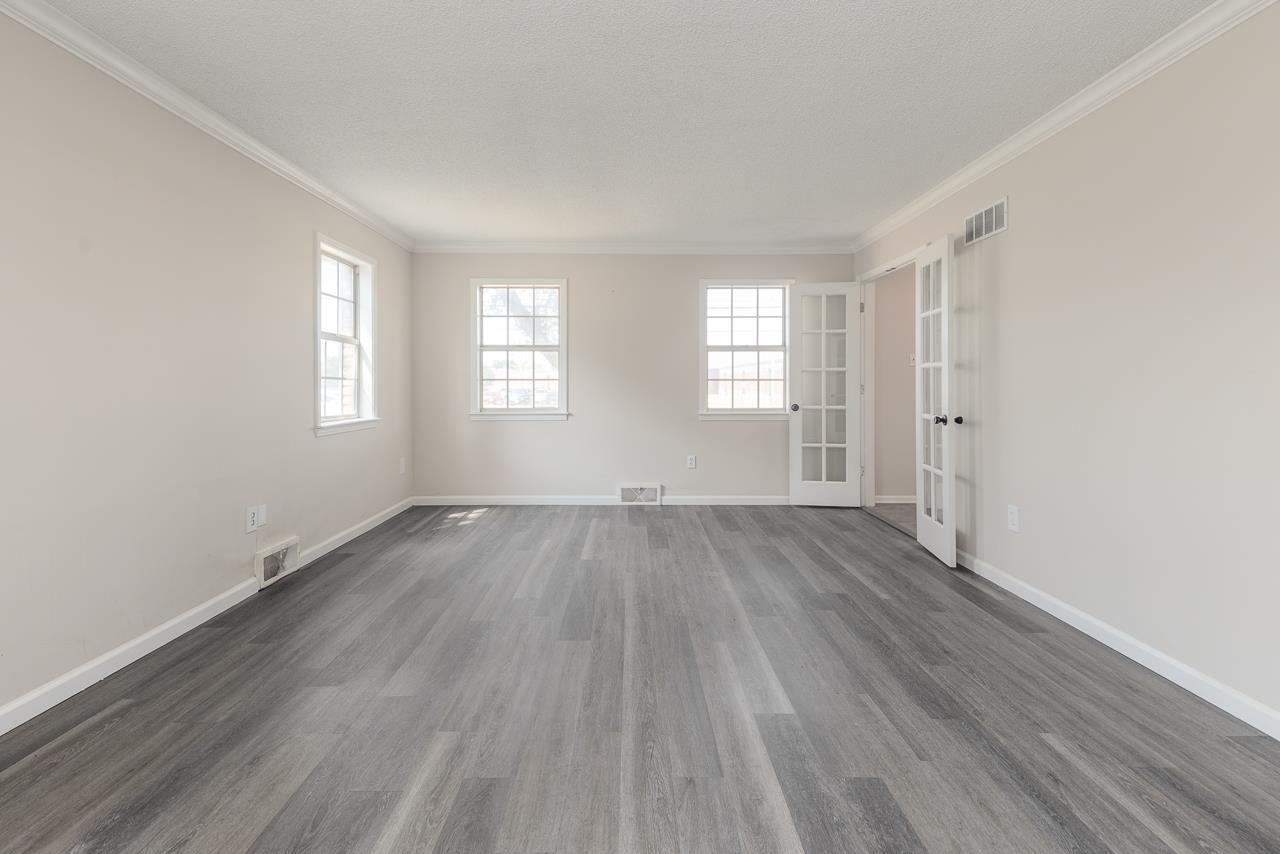 2718 Kate Bond Road Memphis, TN 38133 - Photo 19 of 39 Spare room featuring healthy amount of natural light, wood finished floors, ornamental molding, and french doors