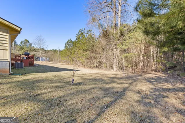 a view of a house with a yard covered in snow