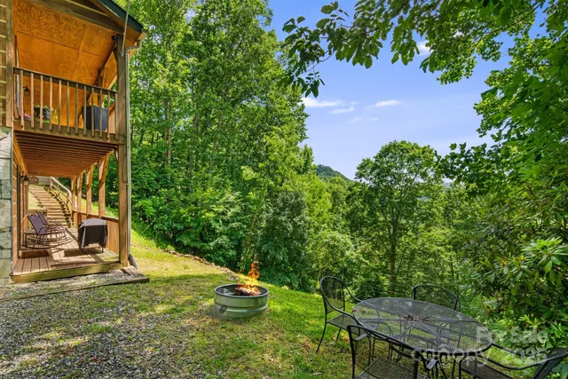 an aerial view of a house with garden space and sitting area