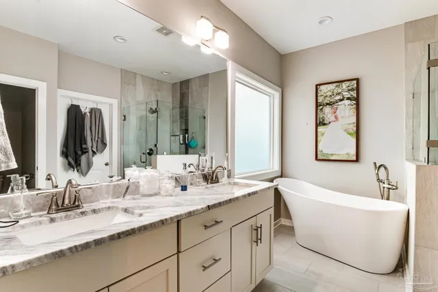 a bathroom with a double vanity sink bathtub and mirror