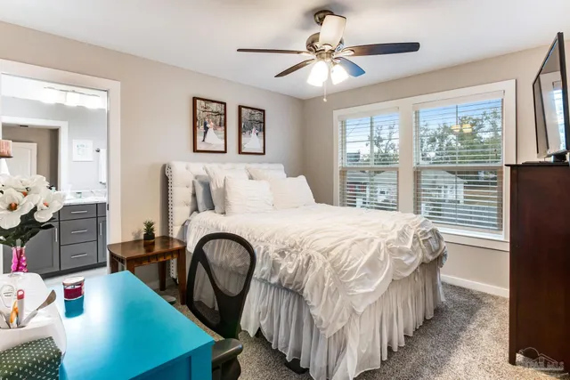 a bedroom with a bed next to a window with the outer view
