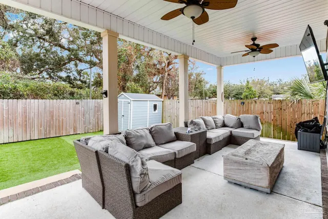 a living room with patio furniture and a floor to ceiling window