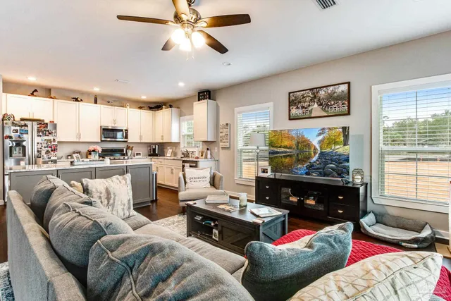 a living room with furniture kitchen and a window