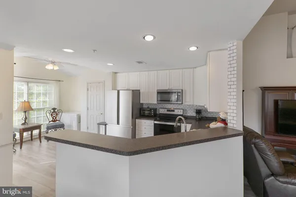a kitchen with a refrigerator sink and microwave