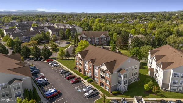 a front view of a residential apartment building with a yard