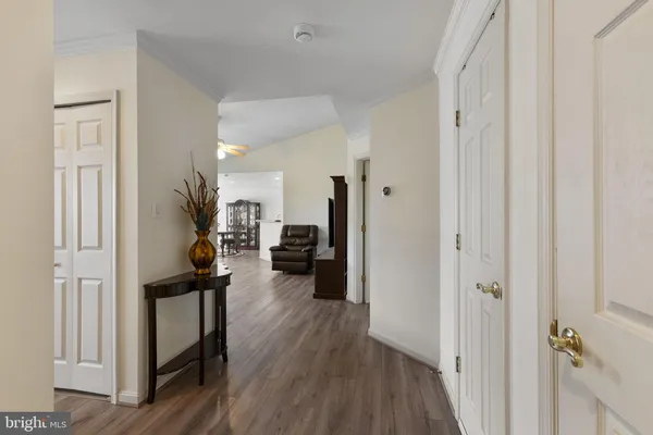 a living room with furniture and a flat screen tv with wooden floor