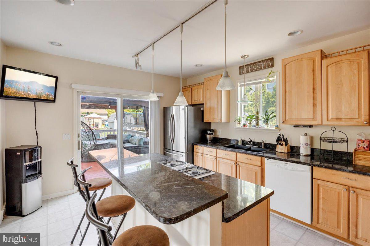 1727 6th Street Ewing, NJ 08638 - Photo 27 of 40 a kitchen with stainless steel appliances granite countertop sink stove top oven and cabinets