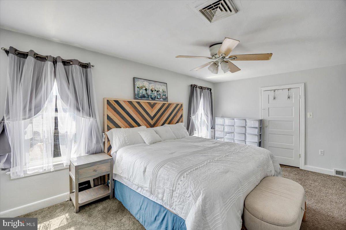 1727 6th Street Ewing, NJ 08638 - Photo 30 of 40 a bedroom with a bed and a chandelier