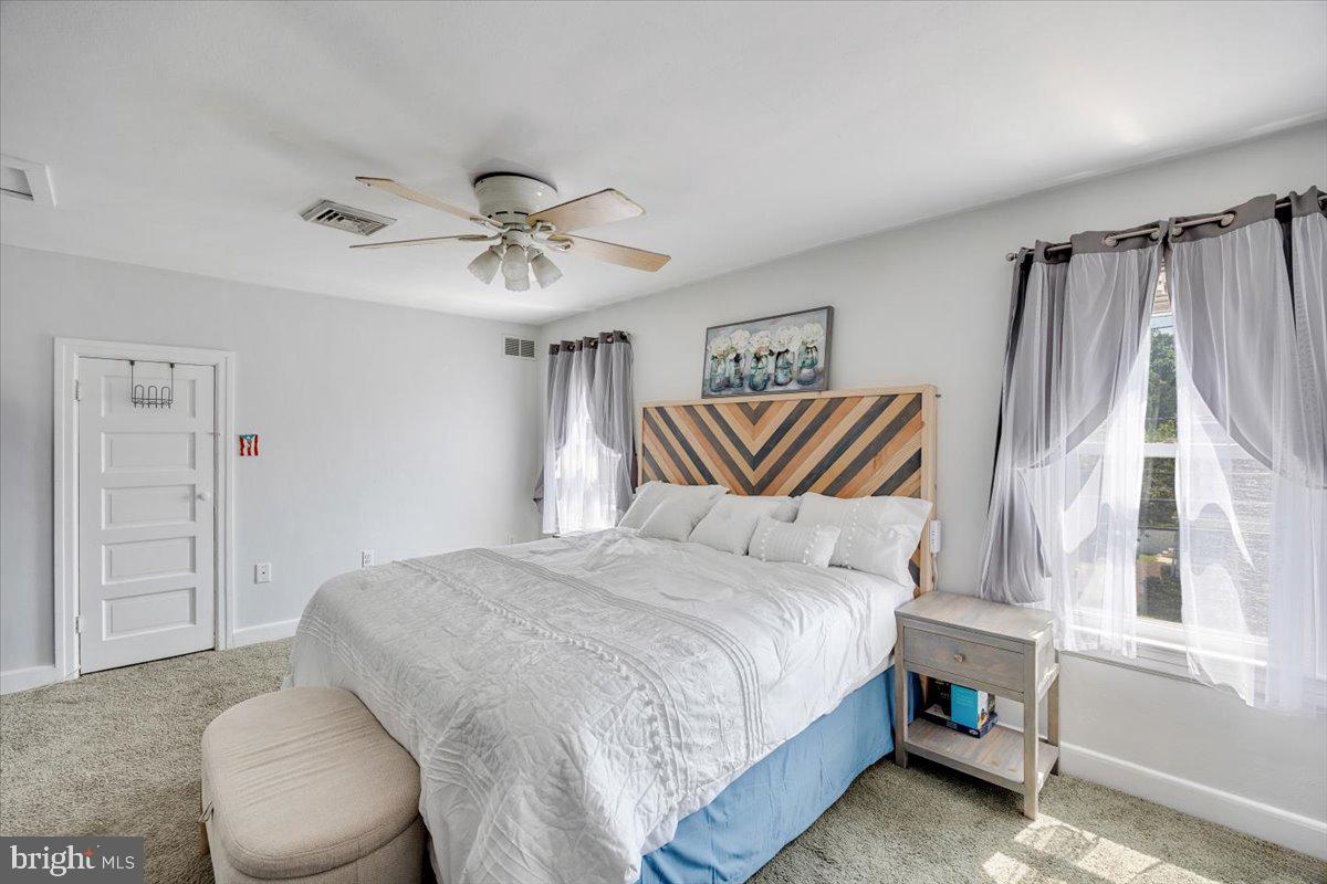 1727 6th Street Ewing, NJ 08638 - Photo 32 of 40 a bedroom with a bed and a chandelier