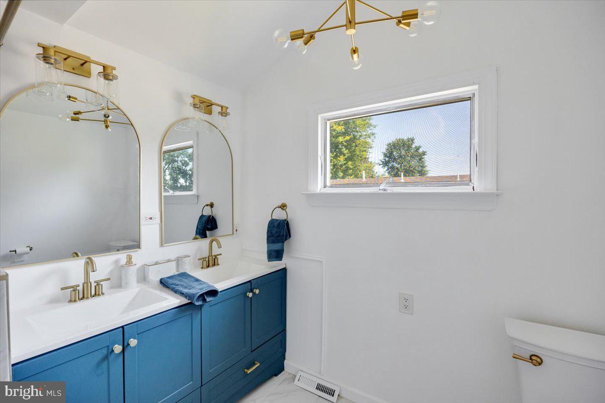 1727 6th Street Ewing, NJ 08638 - Photo 35 of 40 a bathroom with a sink and a mirror