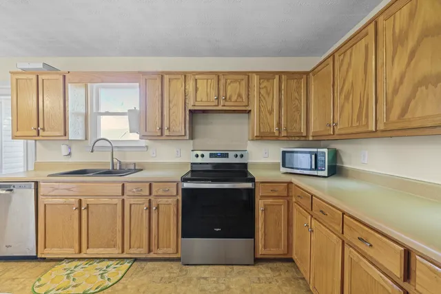 a kitchen with stainless steel appliances granite countertop a stove and a sink