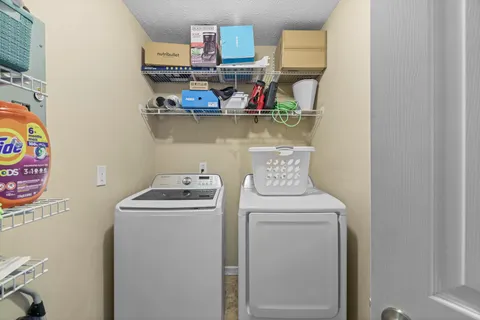 a view of storage and utility room with washer and dryer