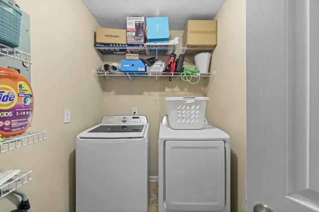 a view of storage and utility room with washer and dryer