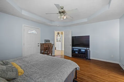 a bedroom with a bed and a television