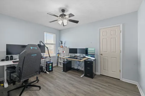 a view of a workspace with furniture and wooden floor