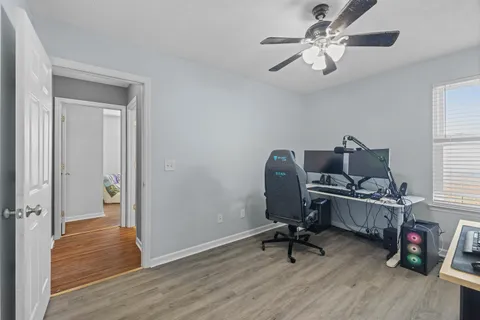 a view of a workspace with furniture and a window