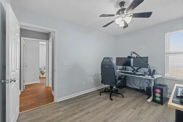 a view of a workspace with furniture and a window