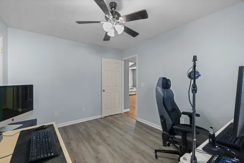 a view of a workspace with furniture and a window