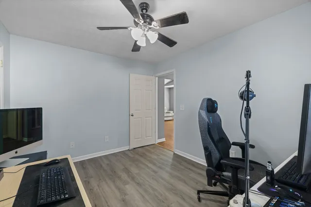 a view of a workspace with furniture and a window