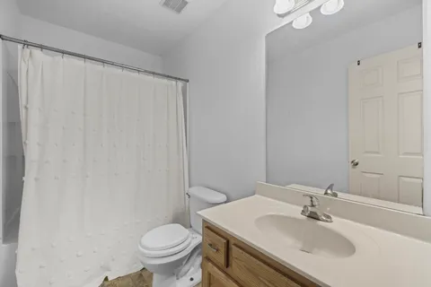 a bathroom with a sink toilet and a mirror