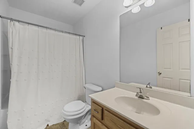 a bathroom with a sink toilet and a mirror