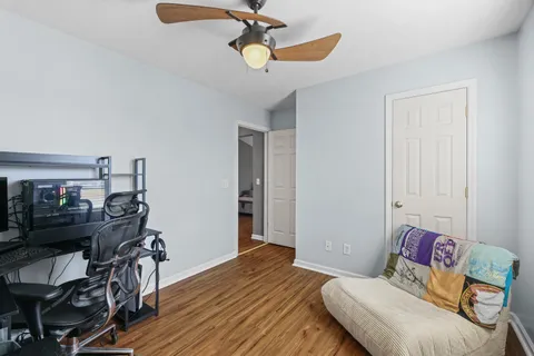 a bedroom with furniture and wooden floor