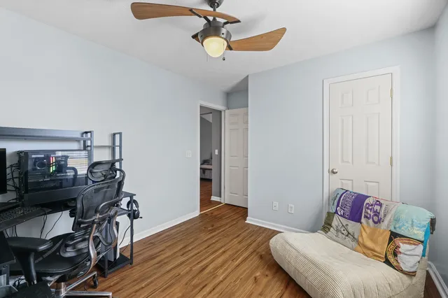 a bedroom with furniture and wooden floor