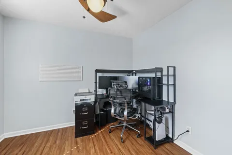 a view of a workspace with furniture and wooden floor