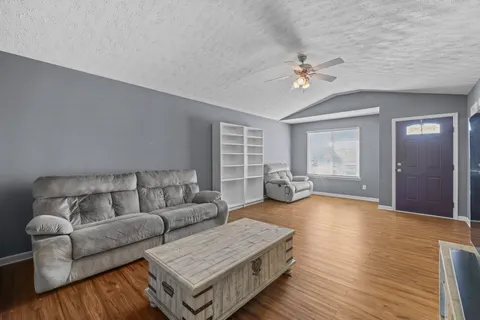 a living room with furniture and wooden floor
