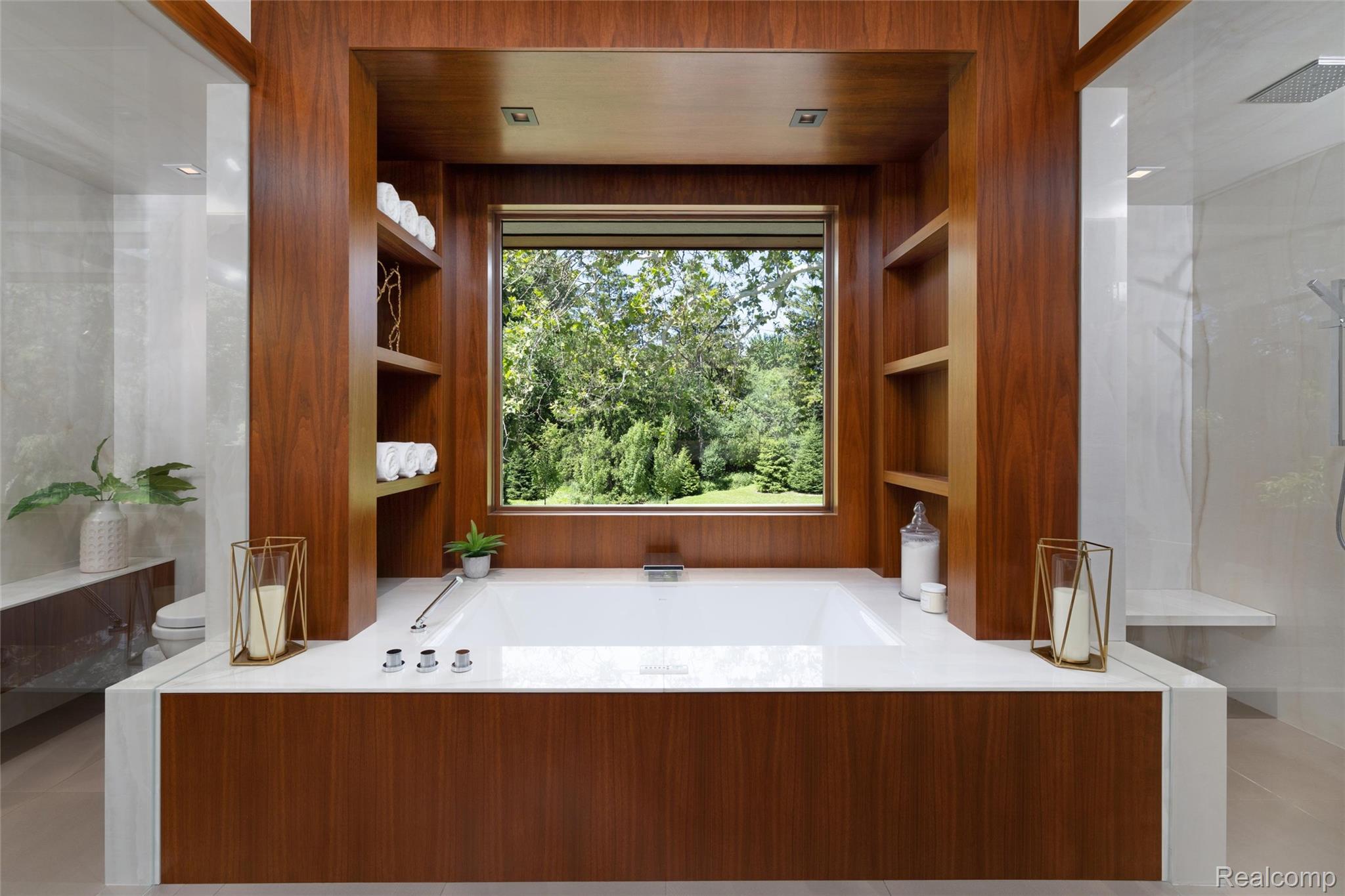 2700 Squirrel Road Bloomfield Hills, MI 48304 - Photo 34 of 83 Soaking tub with a wood-finish surround, integrated shelving, an expansive window, and a white countertop